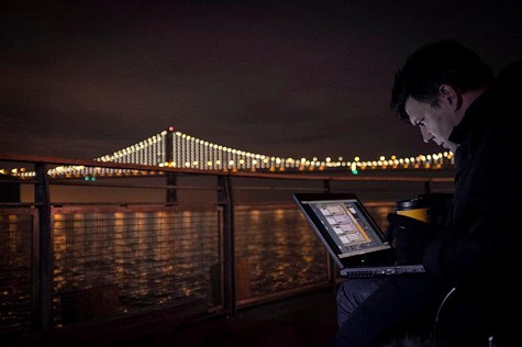 Artist Leo Villareal controls the lights on the Bay Bridge via laptop.