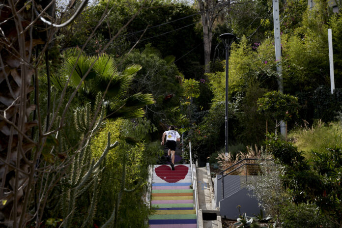 A man runs up stairs in the Silver Lake neighborhood of Los Angeles on Jan. 31, 2021. (Philip Cheung/The New York Times)