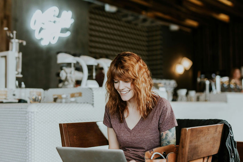 Woman accessing the internet from a laptop