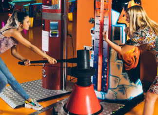 Food and Fun: Best Places to Eat and Play Games in the United States Happy women playing arcade game